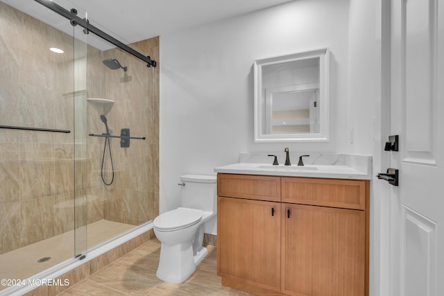 bathroom with vanity, toilet, and a shower stall