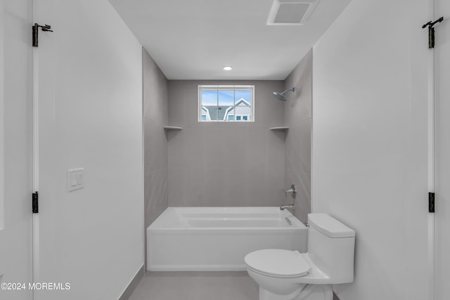 bathroom featuring tiled shower / bath and toilet