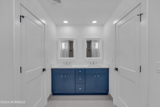 bathroom featuring tile patterned flooring and vanity