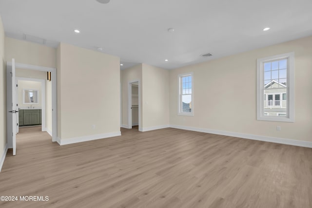 unfurnished room featuring light hardwood / wood-style flooring and a wealth of natural light