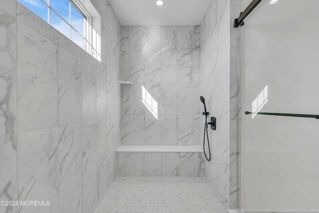 bathroom with a tile shower