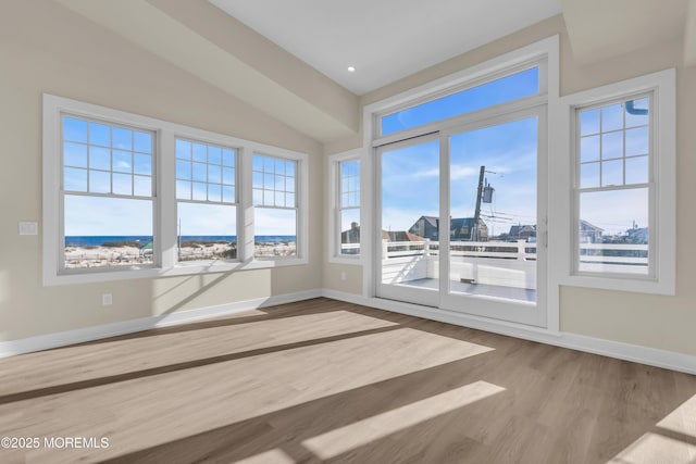 spare room with recessed lighting, baseboards, and wood finished floors