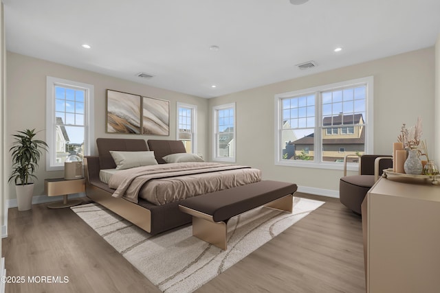 bedroom with visible vents, recessed lighting, baseboards, and light wood-style floors