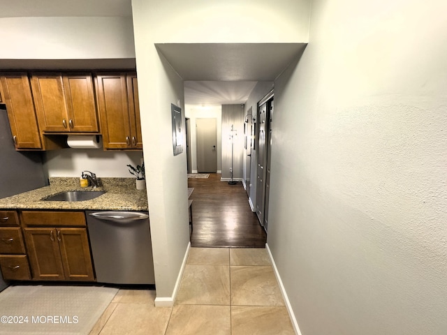 hallway with light wood-type flooring and sink