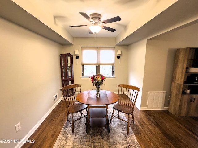 dining space featuring ceiling fan and dark wood-type flooring