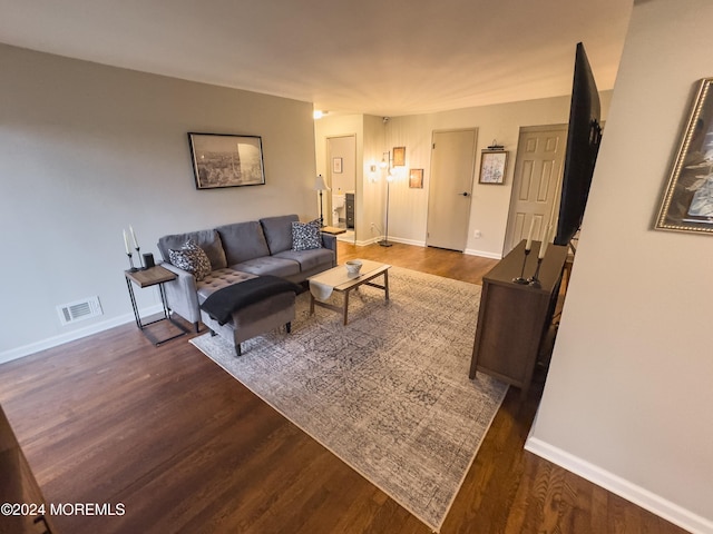 living room with dark hardwood / wood-style floors