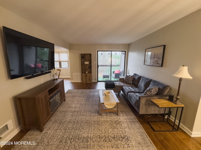 living room with dark hardwood / wood-style flooring