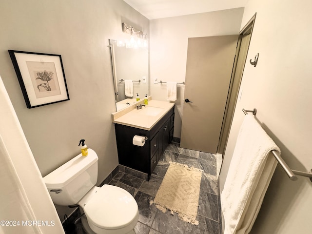 bathroom featuring vanity and toilet