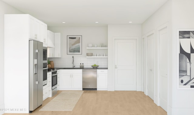 kitchen with decorative backsplash, appliances with stainless steel finishes, light wood-type flooring, sink, and white cabinets