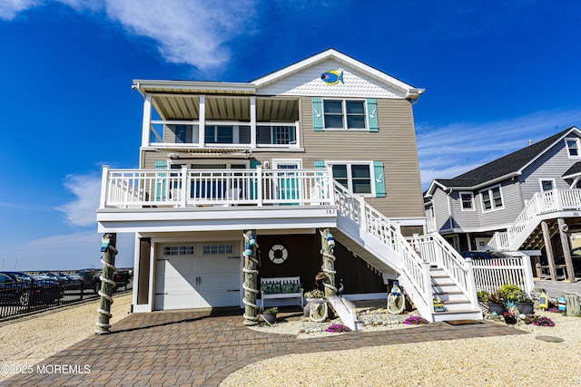 coastal home featuring a porch and a garage