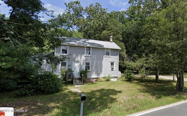 view of side of home featuring a lawn