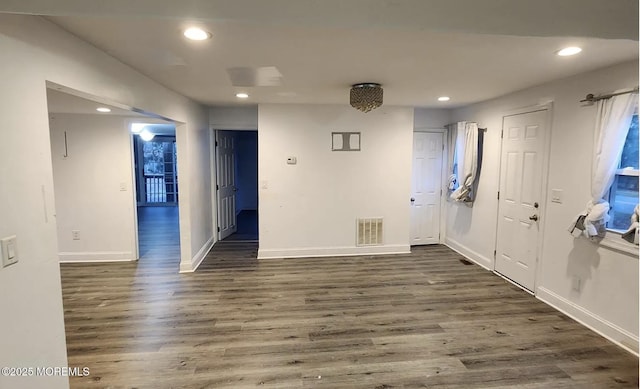 empty room with dark wood-type flooring