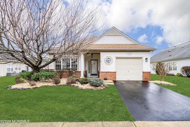 view of front of property featuring a garage and a front lawn