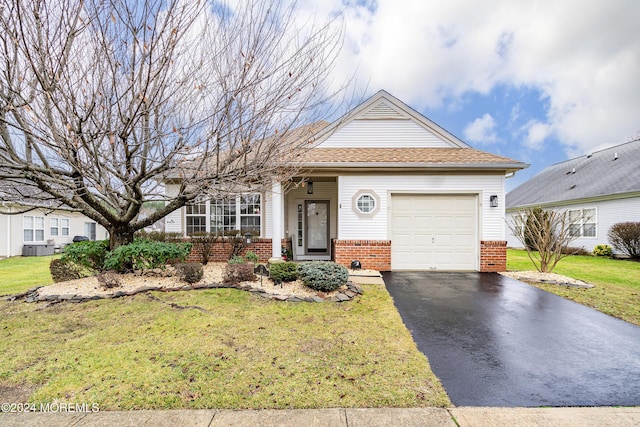 view of front of property featuring a front lawn and a garage