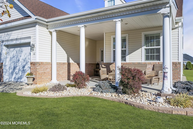 property entrance with covered porch and a garage