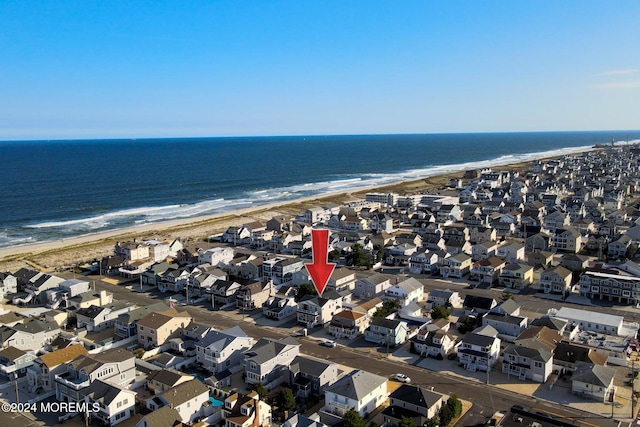 birds eye view of property featuring a view of the beach and a water view