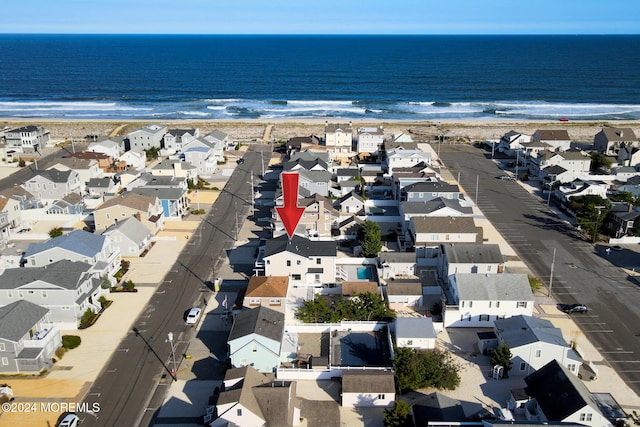 bird's eye view featuring a water view and a view of the beach