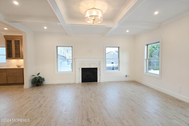 unfurnished living room featuring crown molding, light hardwood / wood-style flooring, beamed ceiling, and coffered ceiling