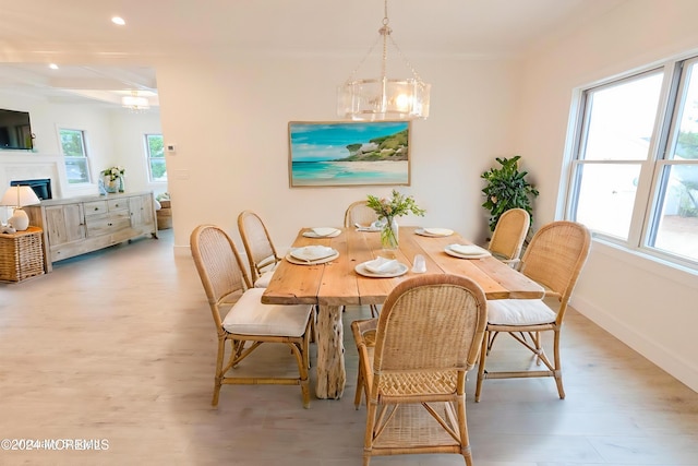 dining space featuring beamed ceiling, light wood-type flooring, and a chandelier