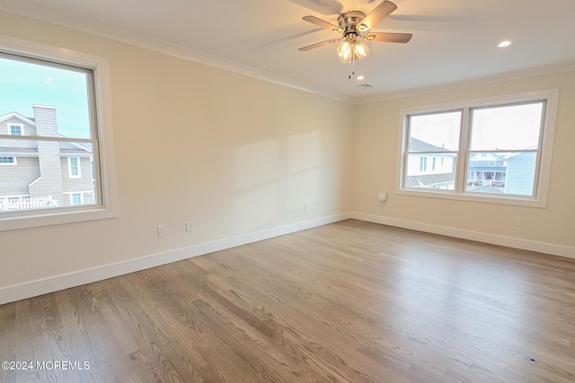 spare room with light wood-type flooring, ceiling fan, and ornamental molding