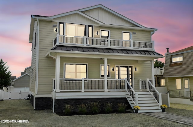 view of front facade with covered porch and a balcony