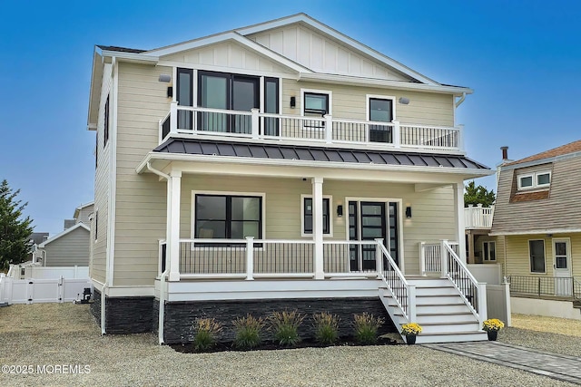 view of front of property featuring a balcony and covered porch