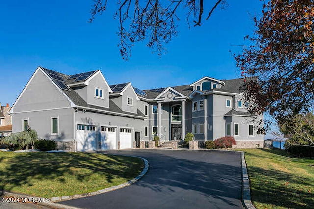 view of front of house featuring a residential view, an attached garage, driveway, and a front yard