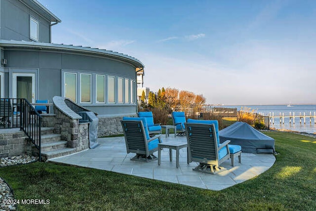 view of patio with a water view