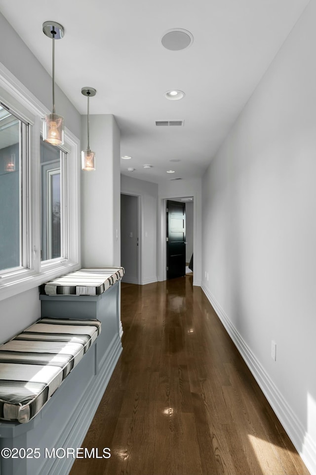 hall with visible vents, recessed lighting, baseboards, and dark wood-style flooring