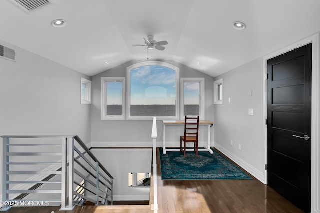 interior space with vaulted ceiling, visible vents, ceiling fan, and wood finished floors