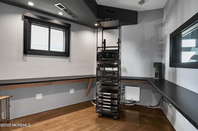 interior space featuring visible vents, baseboards, and wood finished floors