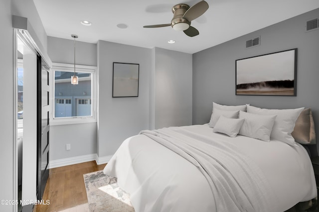 bedroom with visible vents, recessed lighting, baseboards, and wood finished floors