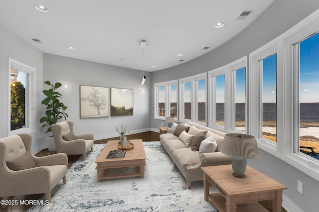 living area featuring wood finished floors, recessed lighting, baseboards, and visible vents