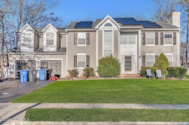 view of property featuring a front yard and a garage