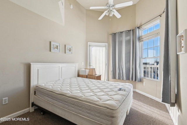 carpeted bedroom featuring a high ceiling