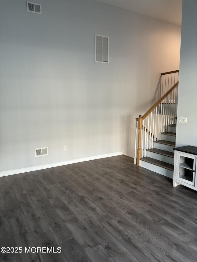 unfurnished living room with dark hardwood / wood-style flooring