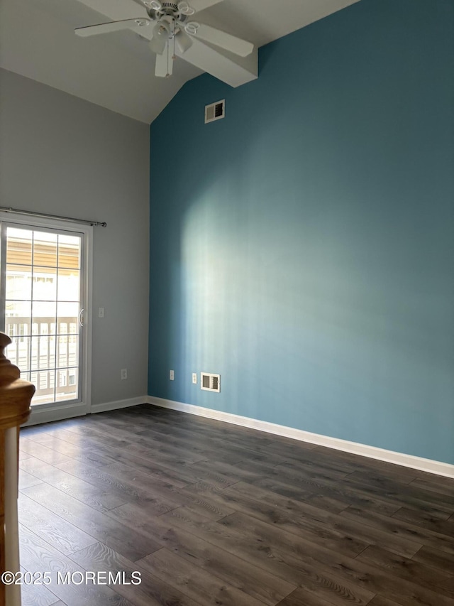 spare room featuring vaulted ceiling, dark hardwood / wood-style floors, and ceiling fan