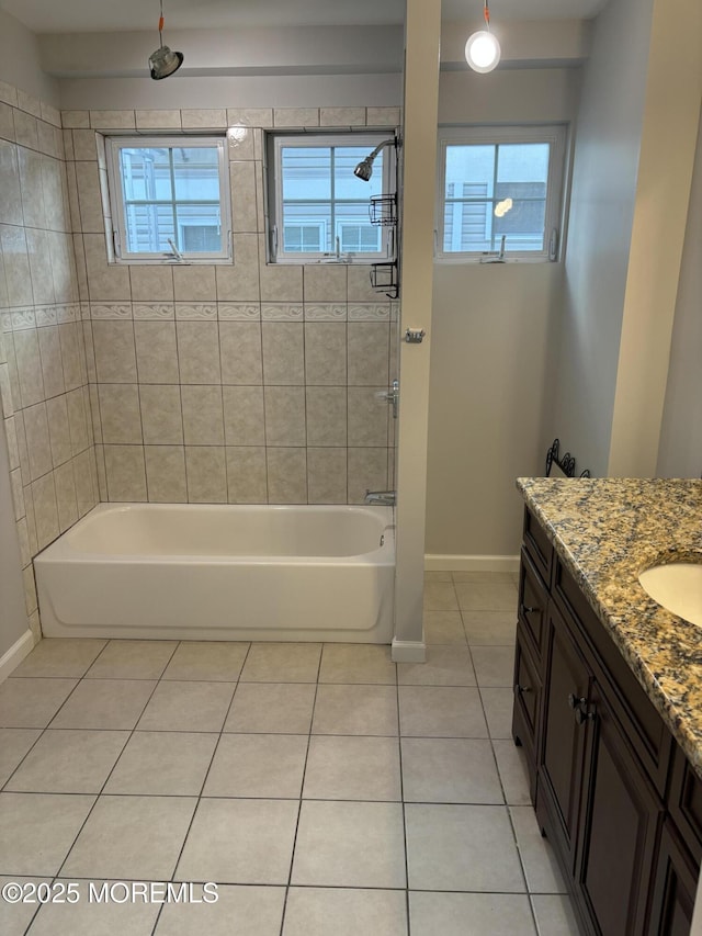 bathroom featuring tiled shower / bath combo, vanity, and tile patterned floors