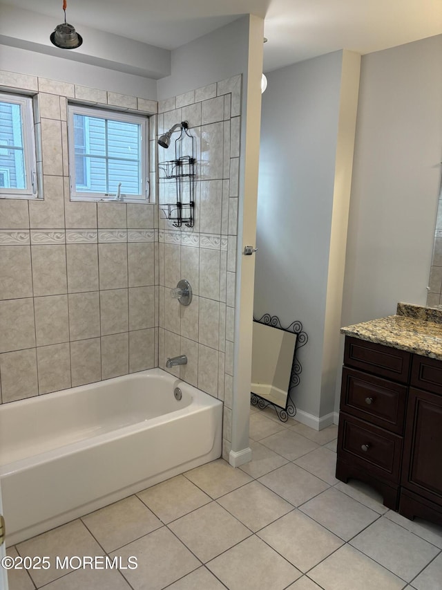 bathroom with tile patterned flooring, vanity, and tiled shower / bath combo