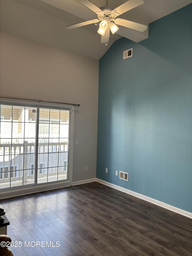 spare room with vaulted ceiling, dark hardwood / wood-style floors, and ceiling fan