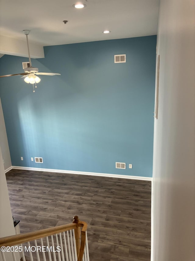 unfurnished room featuring ceiling fan, lofted ceiling, and dark hardwood / wood-style flooring