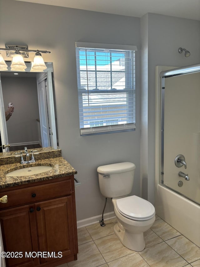 full bathroom with toilet, vanity, bath / shower combo with glass door, and tile patterned flooring