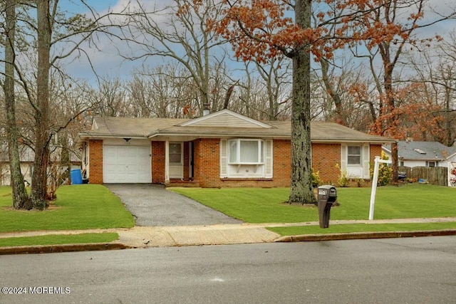 ranch-style house with a front yard and a garage