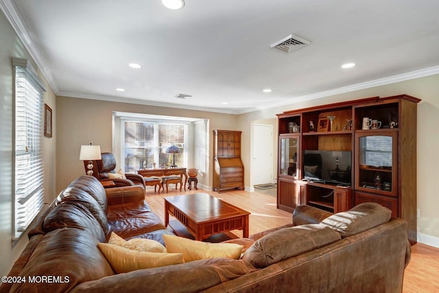 living room with light hardwood / wood-style flooring and ornamental molding