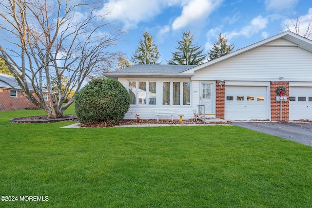 ranch-style home featuring a garage and a front lawn