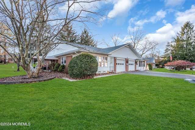 view of front of property with a front lawn and a garage