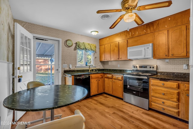 kitchen featuring dishwasher, stainless steel electric stove, light hardwood / wood-style flooring, ceiling fan, and tasteful backsplash