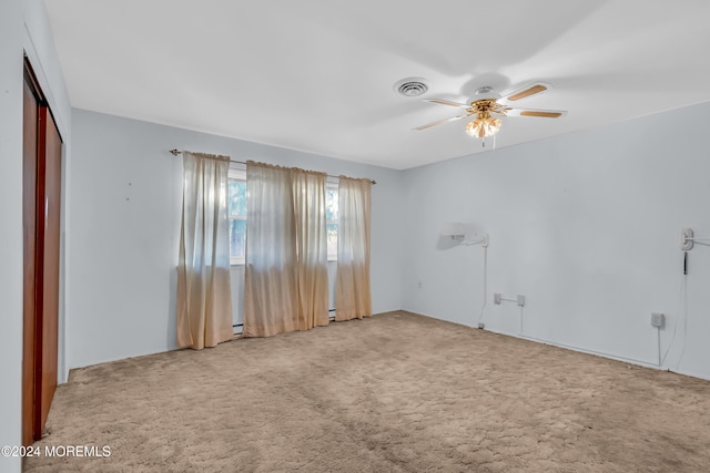 unfurnished room with ceiling fan and carpet floors