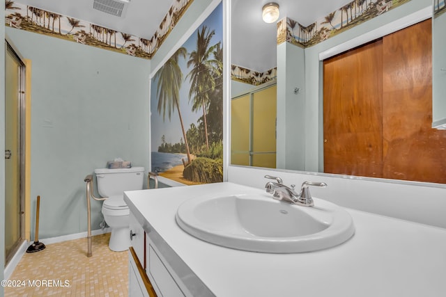 bathroom featuring tile patterned flooring, vanity, and toilet