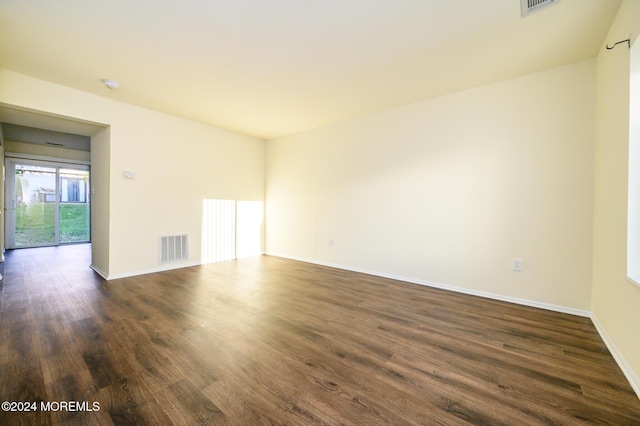 empty room with dark hardwood / wood-style flooring